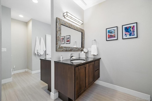 1882 W 67th Ave, Denver, CO 80221 - bathroom featuring vanity, wood finished floors, and recessed lighting