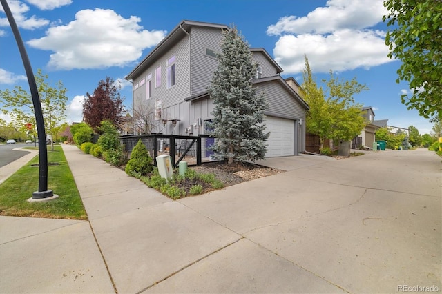 1882 W 67th Ave, Denver, CO 80221 - view of side of home with a garage and driveway