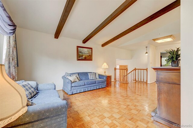 living room with light parquet floors and beamed ceiling