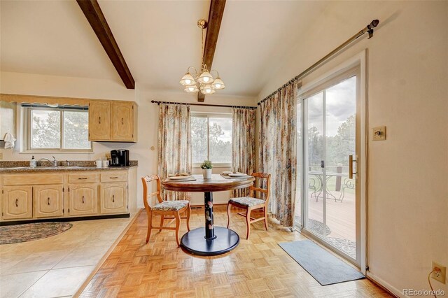 dining room featuring light parquet flooring, beamed ceiling, sink, and a notable chandelier