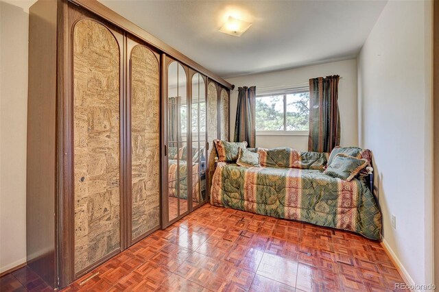 bedroom featuring parquet floors