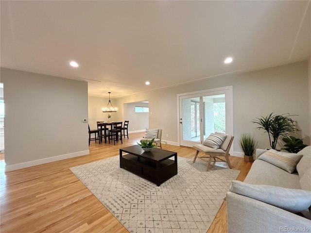 living room featuring a chandelier and light hardwood / wood-style floors