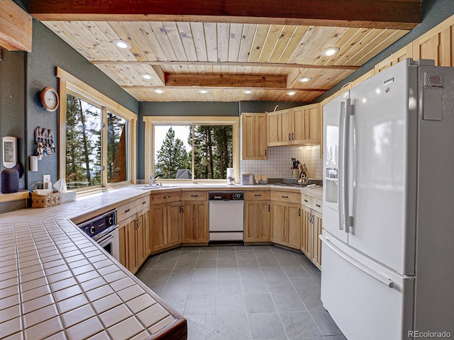 kitchen featuring tile counters, decorative backsplash, wood ceiling, stainless steel appliances, and light brown cabinets