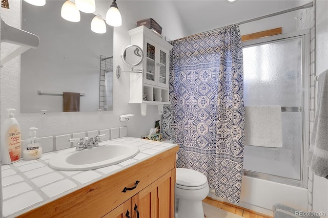 bathroom with toilet, shower / tub combo, and vanity