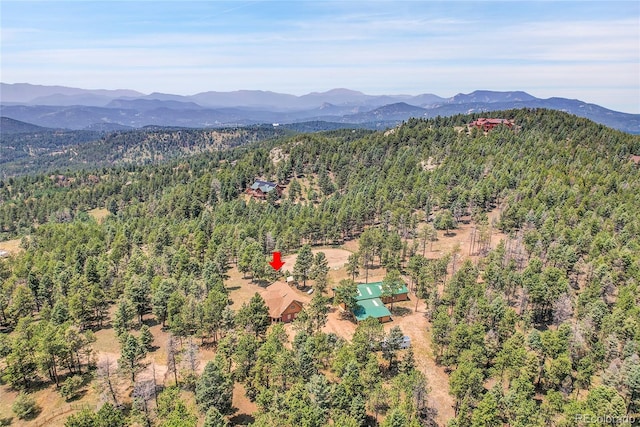 aerial view with a mountain view and a view of trees