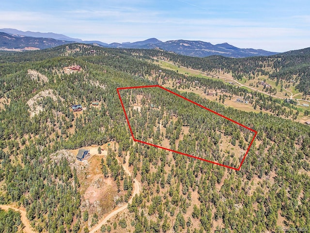 aerial view featuring a mountain view and a view of trees