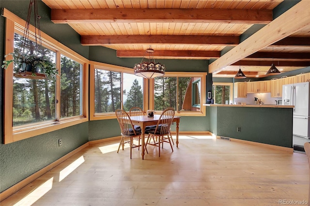 26526 Gray Buck Trl, Conifer, CO 80433 - dining area featuring wood ceiling with exposed beams, baseboards, a chandelier, and light wood-style flooring