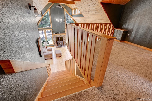 26526 Gray Buck Trl, Conifer, CO 80433 - staircase with healthy amount of natural light, ceiling fan, carpet flooring, a wood stove, and high vaulted ceiling