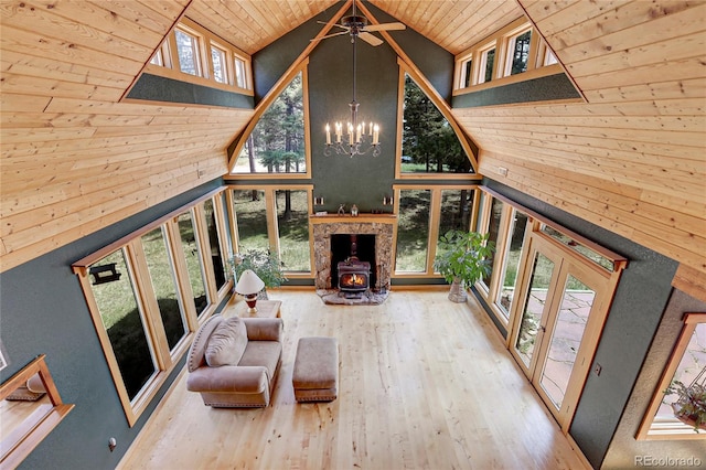 26526 Gray Buck Trl, Conifer, CO 80433 - living area with high vaulted ceiling, wooden ceiling, wood finished floors, wooden walls, and a wood stove