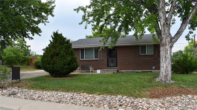 1029 W 102nd Pl, Northglenn, CO 80260 - ranch-style house featuring brick siding, a front lawn, and roof with shingles