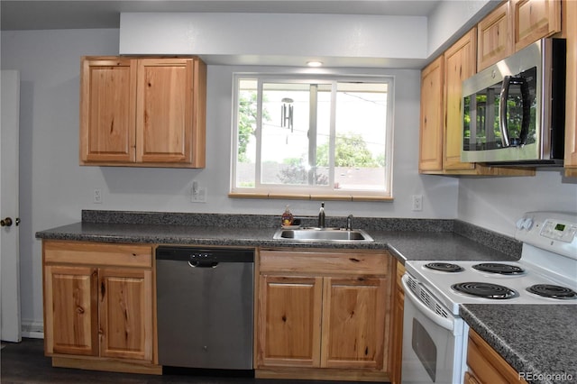 1029 W 102nd Pl, Northglenn, CO 80260 - kitchen with stainless steel appliances and dark countertops