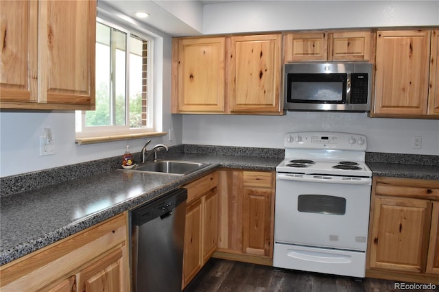 1029 W 102nd Pl, Northglenn, CO 80260 - kitchen with appliances with stainless steel finishes, dark countertops, and dark wood finished floors