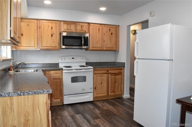 1029 W 102nd Pl, Northglenn, CO 80260 - kitchen with white appliances, dark wood-style flooring, dark countertops, and recessed lighting