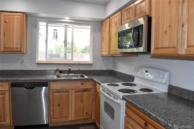 1029 W 102nd Pl, Northglenn, CO 80260 - kitchen with stainless steel appliances and dark countertops