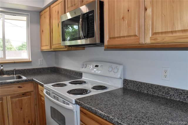 1029 W 102nd Pl, Northglenn, CO 80260 - kitchen featuring stainless steel microwave, white electric stove, and dark countertops