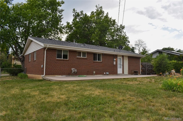 1029 W 102nd Pl, Northglenn, CO 80260 - rear view of house with a patio and brick siding