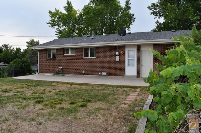 1029 W 102nd Pl, Northglenn, CO 80260 - rear view of property with a patio, brick siding, and a shingled roof