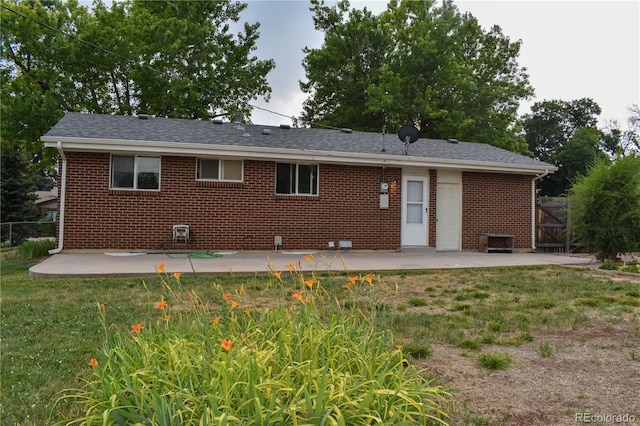 1029 W 102nd Pl, Northglenn, CO 80260 - back of property with a patio area, brick siding, and a gate