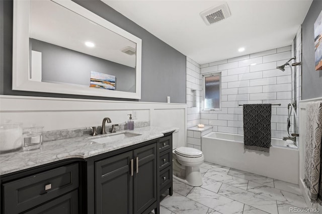 bathroom with visible vents, toilet, marble finish floor, bathing tub / shower combination, and vanity