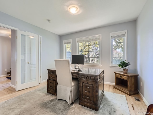 office with light wood-type flooring