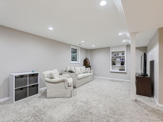 carpeted living room featuring built in shelves