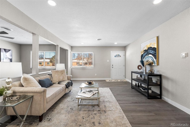 living room featuring recessed lighting, visible vents, a textured ceiling, wood finished floors, and baseboards