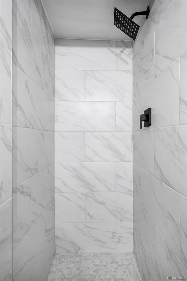 full bath with a tile shower