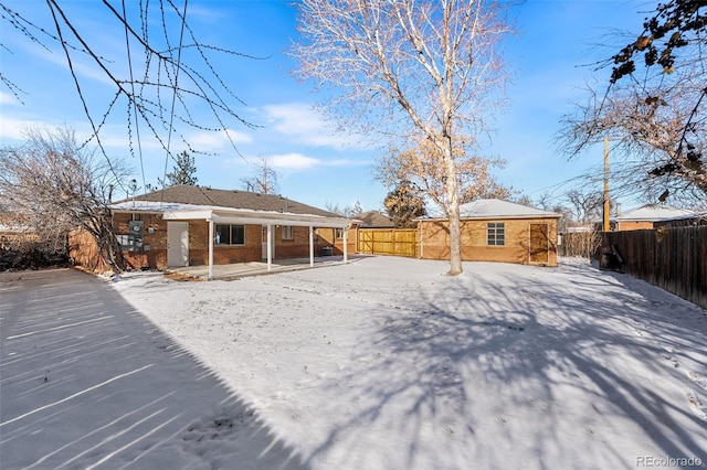 back of house with an outbuilding, brick siding, and a fenced backyard