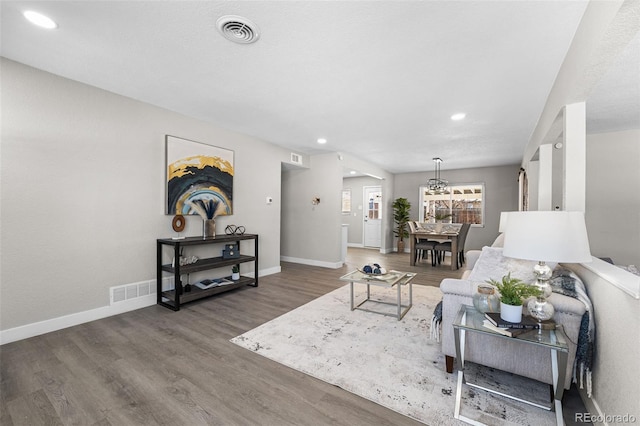 living area featuring recessed lighting, wood finished floors, visible vents, and baseboards