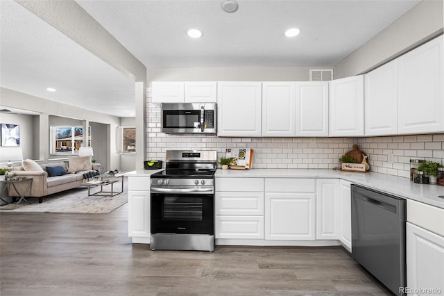 kitchen featuring light wood-style floors, visible vents, stainless steel appliances, and light countertops