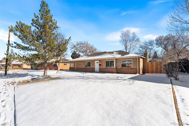 single story home featuring brick siding and fence