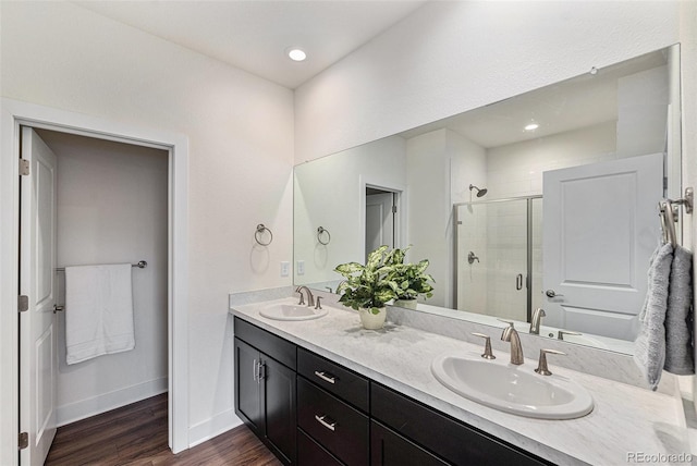 12336 W 52nd Ave, Wheat Ridge, CO 80033 - full bathroom featuring double vanity, a shower stall, and wood finished floors