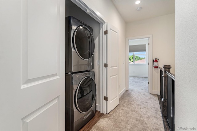 12336 W 52nd Ave, Wheat Ridge, CO 80033 - laundry room with stacked washing machine and dryer, carpet flooring, and recessed lighting