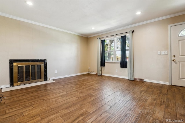3616 W Radcliff Ave, Denver, CO 80236 - unfurnished living room with wood finished floors, crown molding, recessed lighting, baseboards, and a fireplace with flush hearth