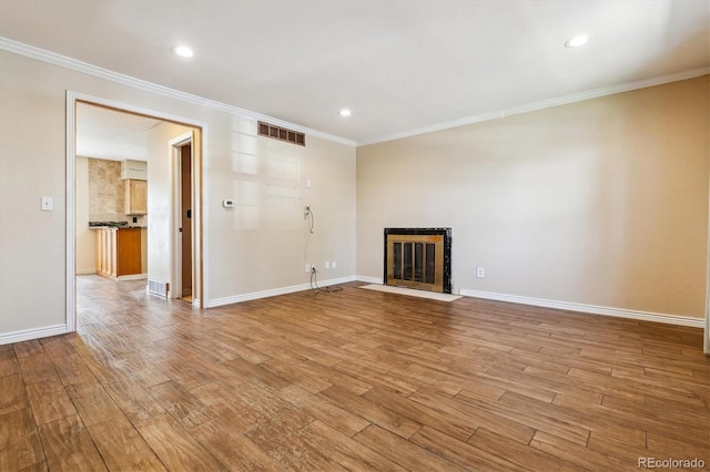 3616 W Radcliff Ave, Denver, CO 80236 - unfurnished living room with a fireplace with flush hearth, light wood finished floors, crown molding, baseboards, and recessed lighting