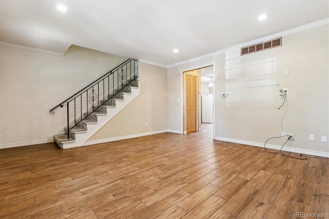 3616 W Radcliff Ave, Denver, CO 80236 - unfurnished living room featuring ornamental molding, light wood-style floors, stairs, baseboards, and recessed lighting