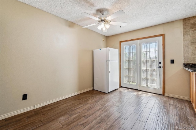 3616 W Radcliff Ave, Denver, CO 80236 - empty room featuring dark wood-style flooring, a textured ceiling, ceiling fan, and baseboards