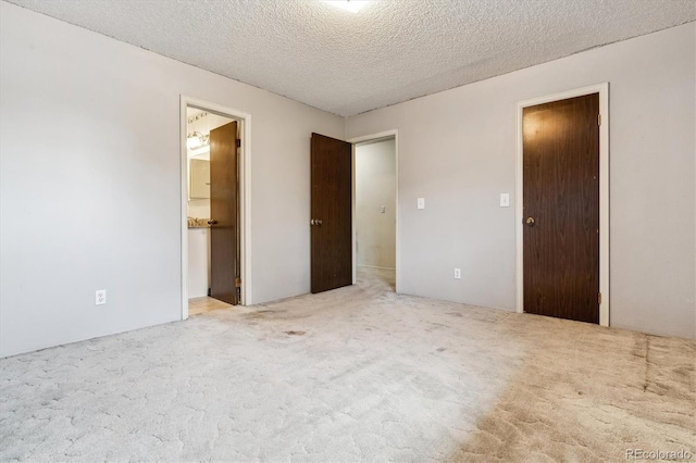 3616 W Radcliff Ave, Denver, CO 80236 - unfurnished bedroom featuring carpet floors, a textured ceiling, and ensuite bath