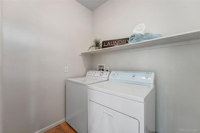 laundry room with separate washer and dryer, light wood finished floors, and baseboards