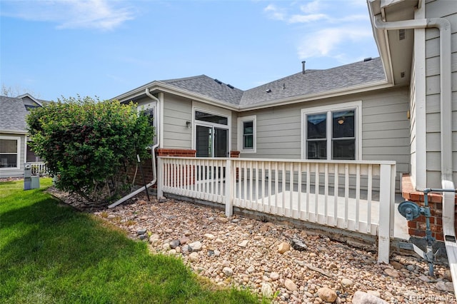 back of property with roof with shingles