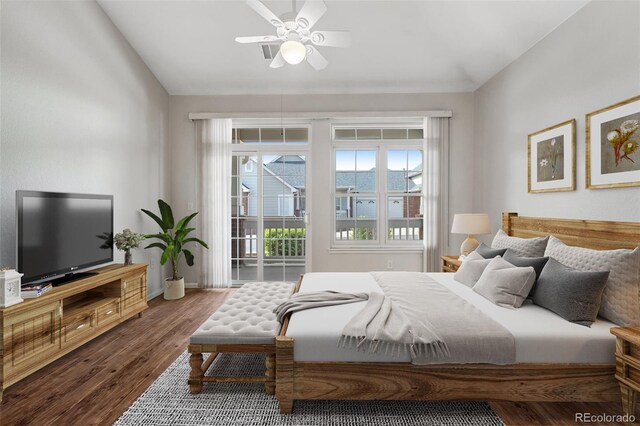 bedroom featuring lofted ceiling, wood finished floors, access to outside, baseboards, and ceiling fan