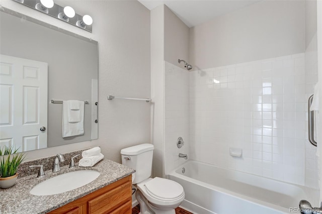 bathroom featuring toilet, vanity, and tub / shower combination