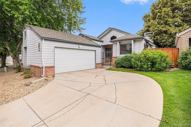 11196 E Baltic Dr, Aurora, CO 80014 - view of front of home with an attached garage, concrete driveway, roof with shingles, brick siding, and a gate