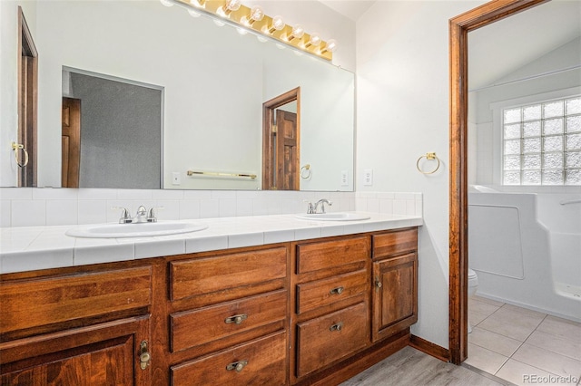 11196 E Baltic Dr, Aurora, CO 80014 - full bathroom featuring double vanity and vaulted ceiling