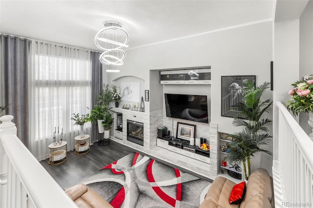 3818 S Dallas St, Aurora, CO 80014 - living room featuring wood finished floors, a fireplace, and a chandelier