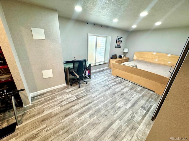 3818 S Dallas St, Aurora, CO 80014 - bedroom with recessed lighting, wood finished floors, a textured ceiling, a textured wall, and baseboards