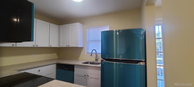 kitchen with dishwasher, refrigerator, white cabinetry, and sink