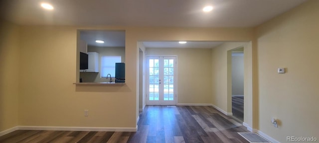 interior space with sink, dark wood-type flooring, and french doors