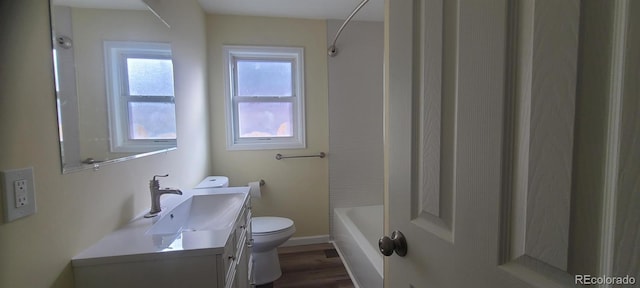 full bathroom featuring shower / bath combination, vanity, wood-type flooring, and toilet