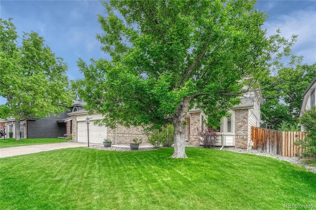 19149 E Ida Dr, Aurora, CO 80015 - view of property hidden behind natural elements with concrete driveway, brick siding, and a garage